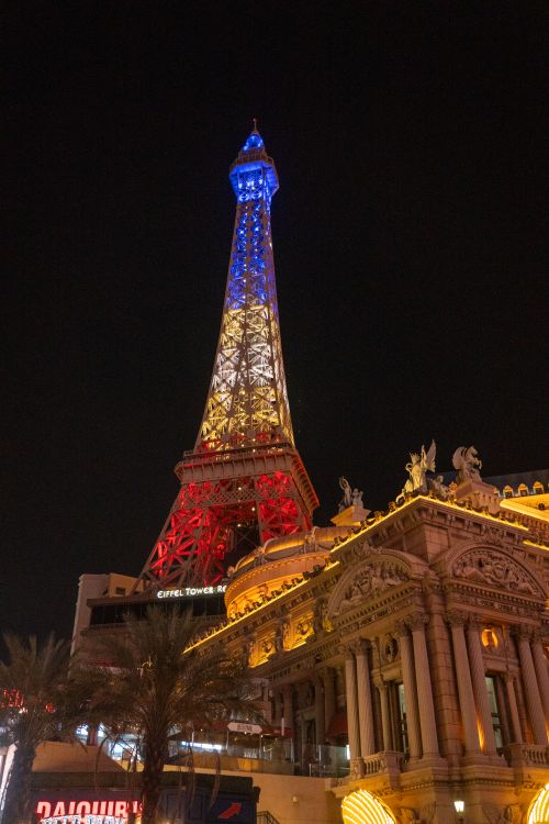 Free The illuminated Eiffel Tower replica at Las Vegas Hotel and Casino glowing at night. Stock Photo