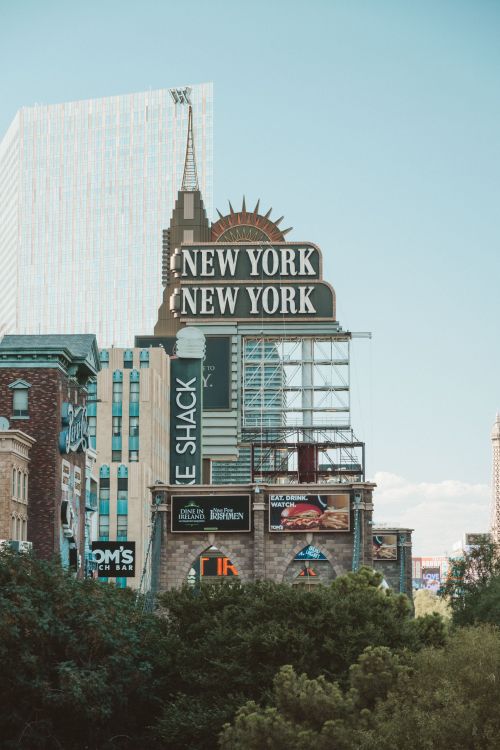 Free Daytime view of the New York-New York Hotel sign with surrounding architecture in Las Vegas. Stock Photo