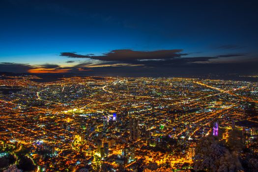A stunning aerial view of Bogota city lights under a twilight sky.