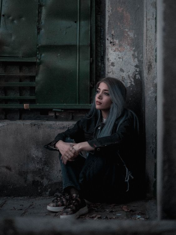 Contemplative Woman in Urban Setting · Free Stock Photo