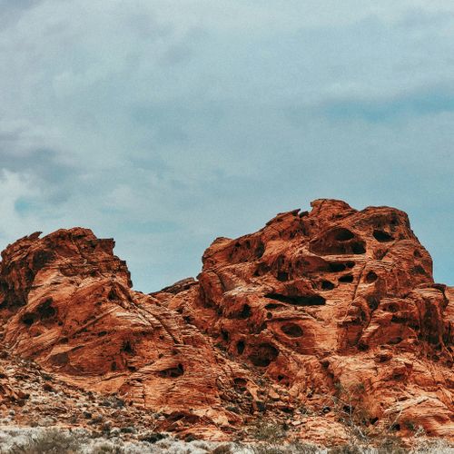 Free Majestic red rock formations with intricate textures under a vast blue sky, capturing natural beauty. Stock Photo