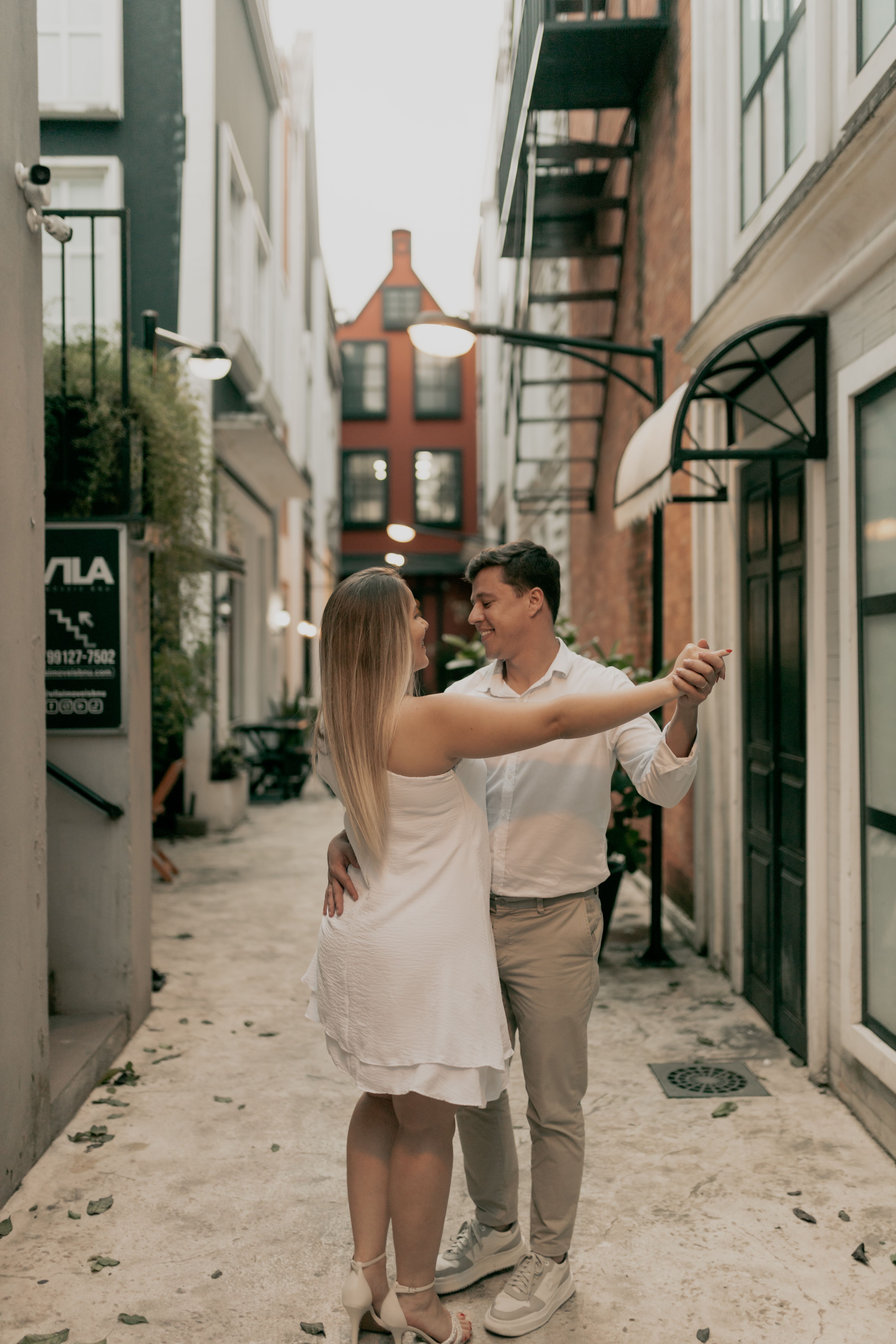 Latin — couple dancing in a charming city alley. Stock photo.