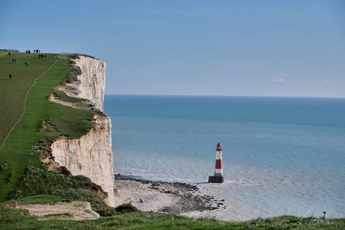 Free Majestic cliffs at Beachy Head with lighthouse on a bright day overlooking the ocean Stock Photo