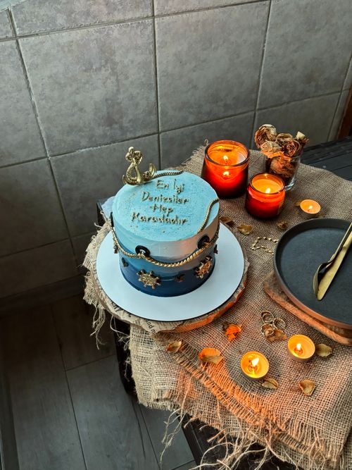 Free A rustic blue cake with candles on burlap, creating a warm atmosphere. Stock Photo