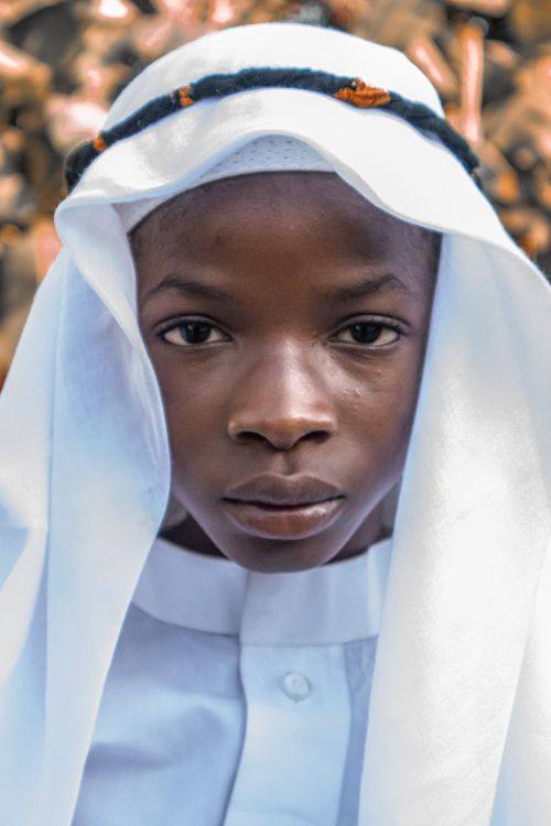 Free A close-up portrait of a boy wearing traditional attire with a focus on his face. Stock Photo