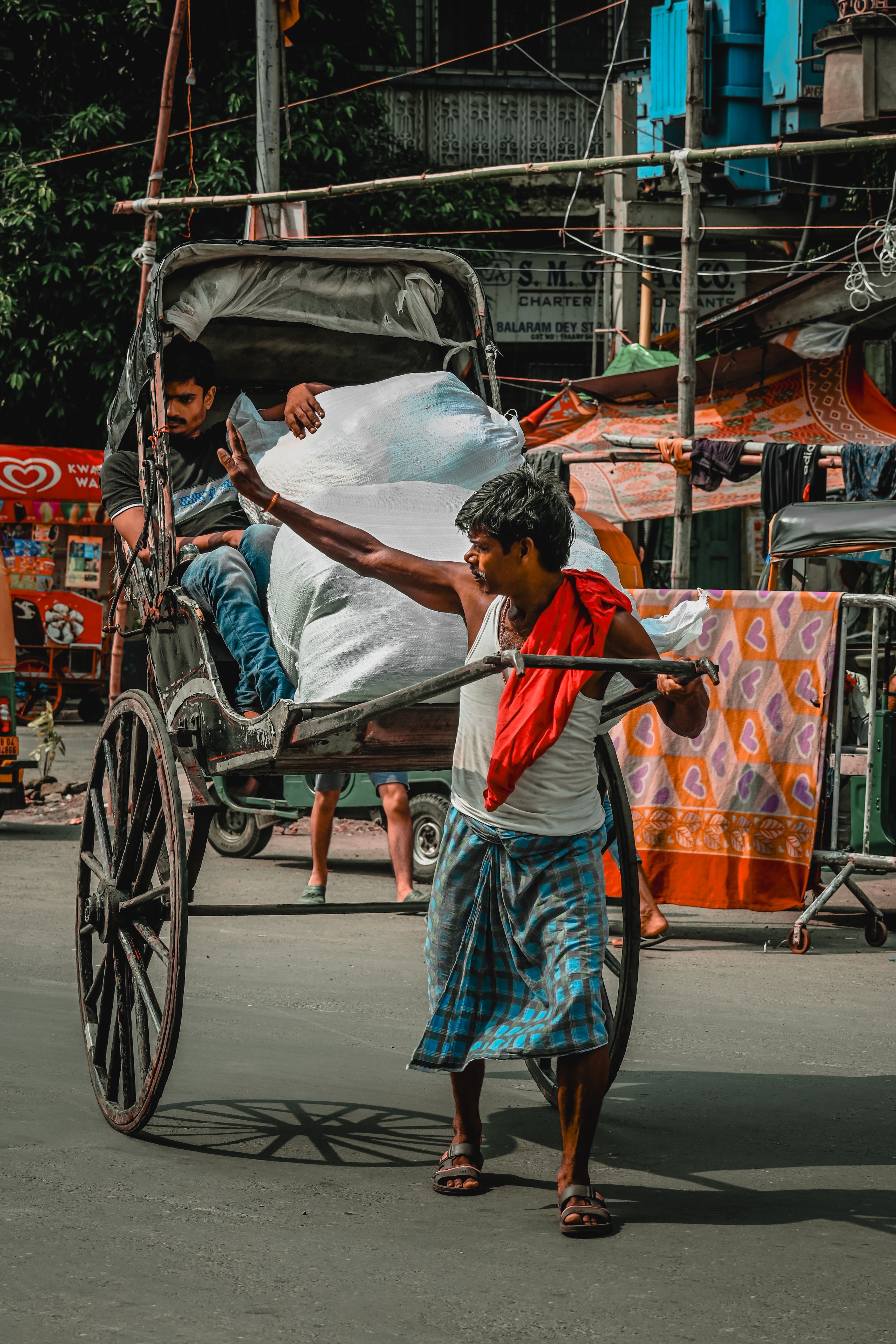Rickshaw Puller Navigating Kolkata Streets · Free Stock Photo