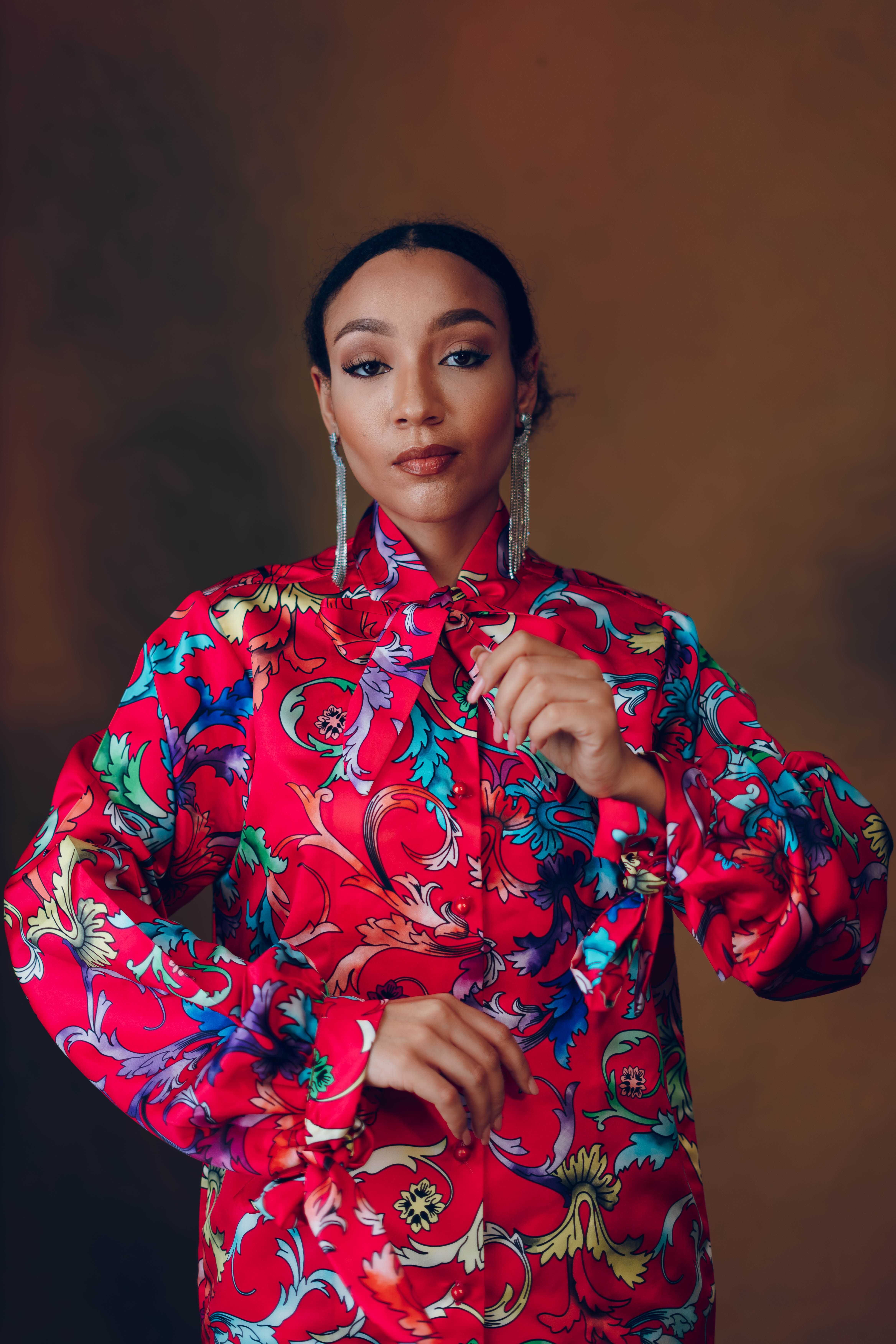 Captivating portrait of a model in colorful attire expressing bold fashion and beauty.