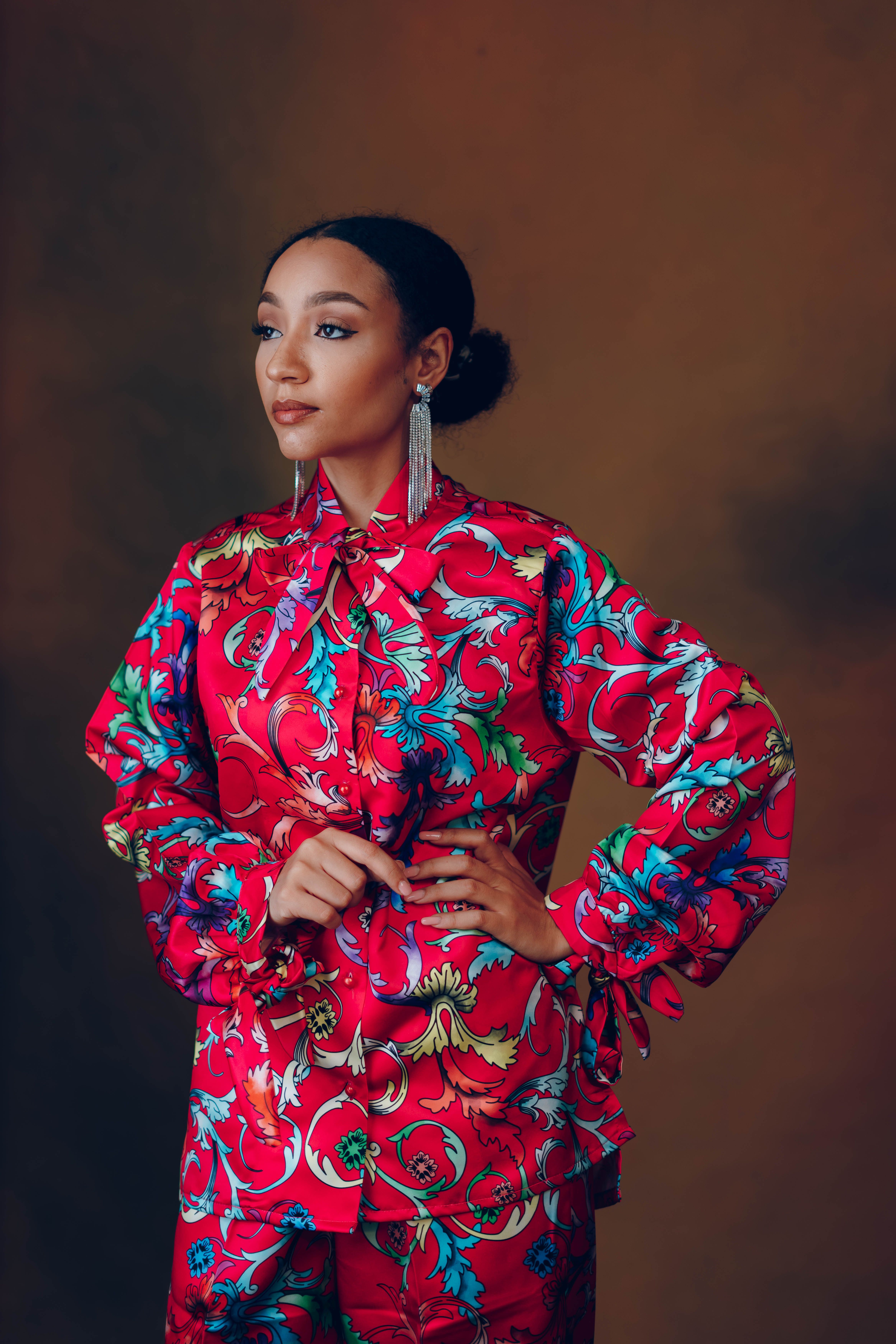 Striking portrait of a model wearing colorful patterned attire, showcasing elegance and style.