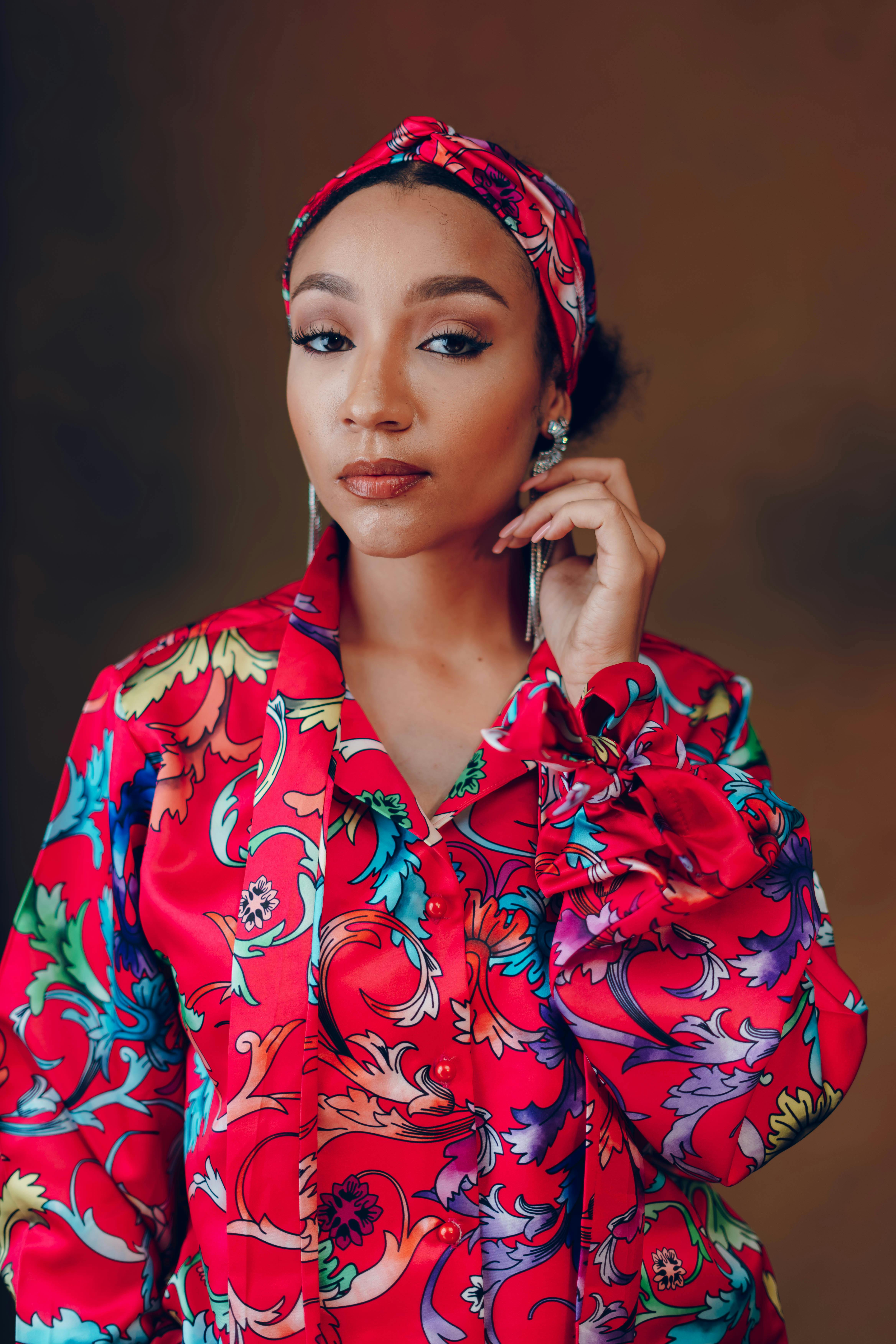 Portrait of a woman in colorful floral fashion, embodying elegance and style.