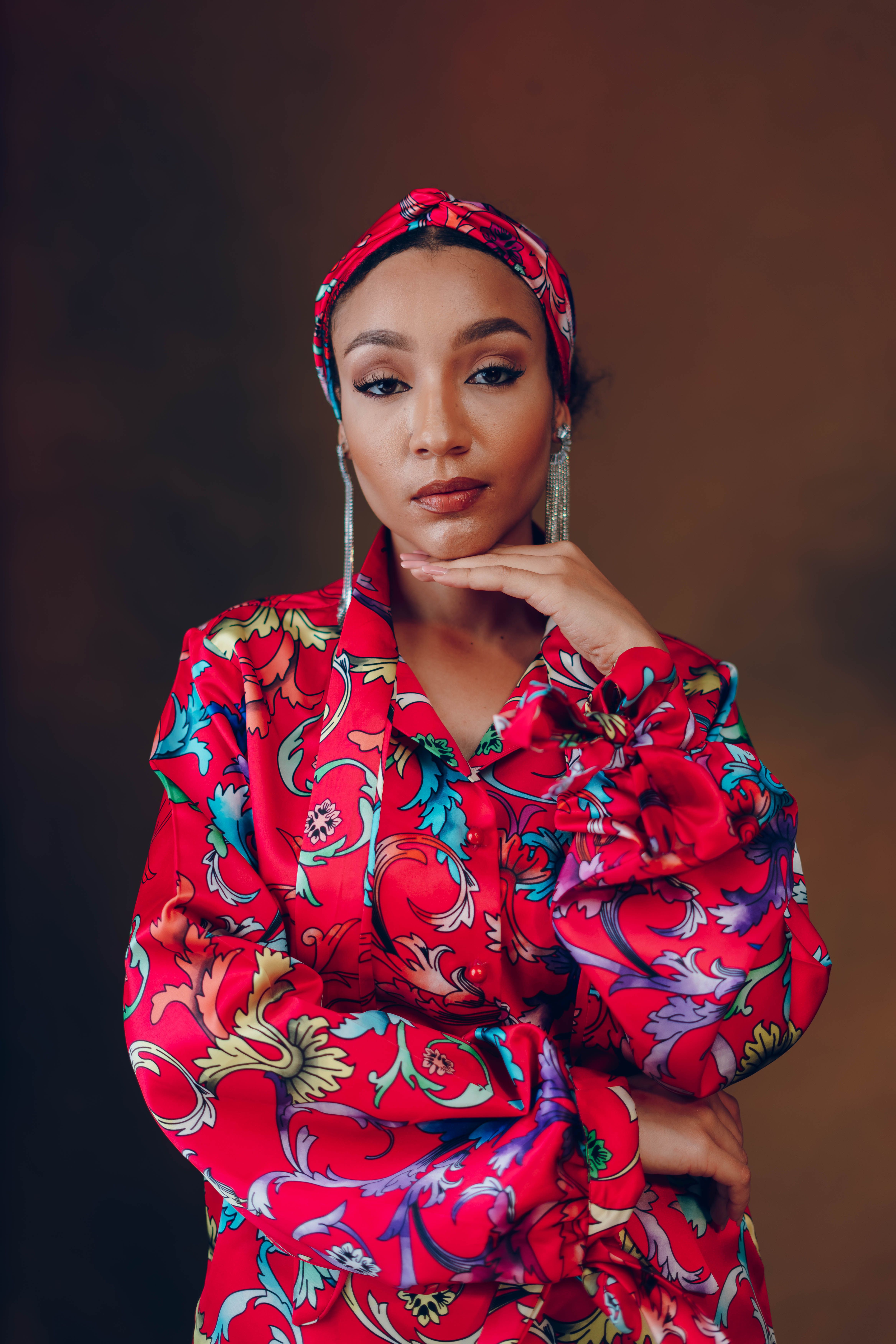 Striking portrait of a black woman in colorful fabric, showcasing African fashion.