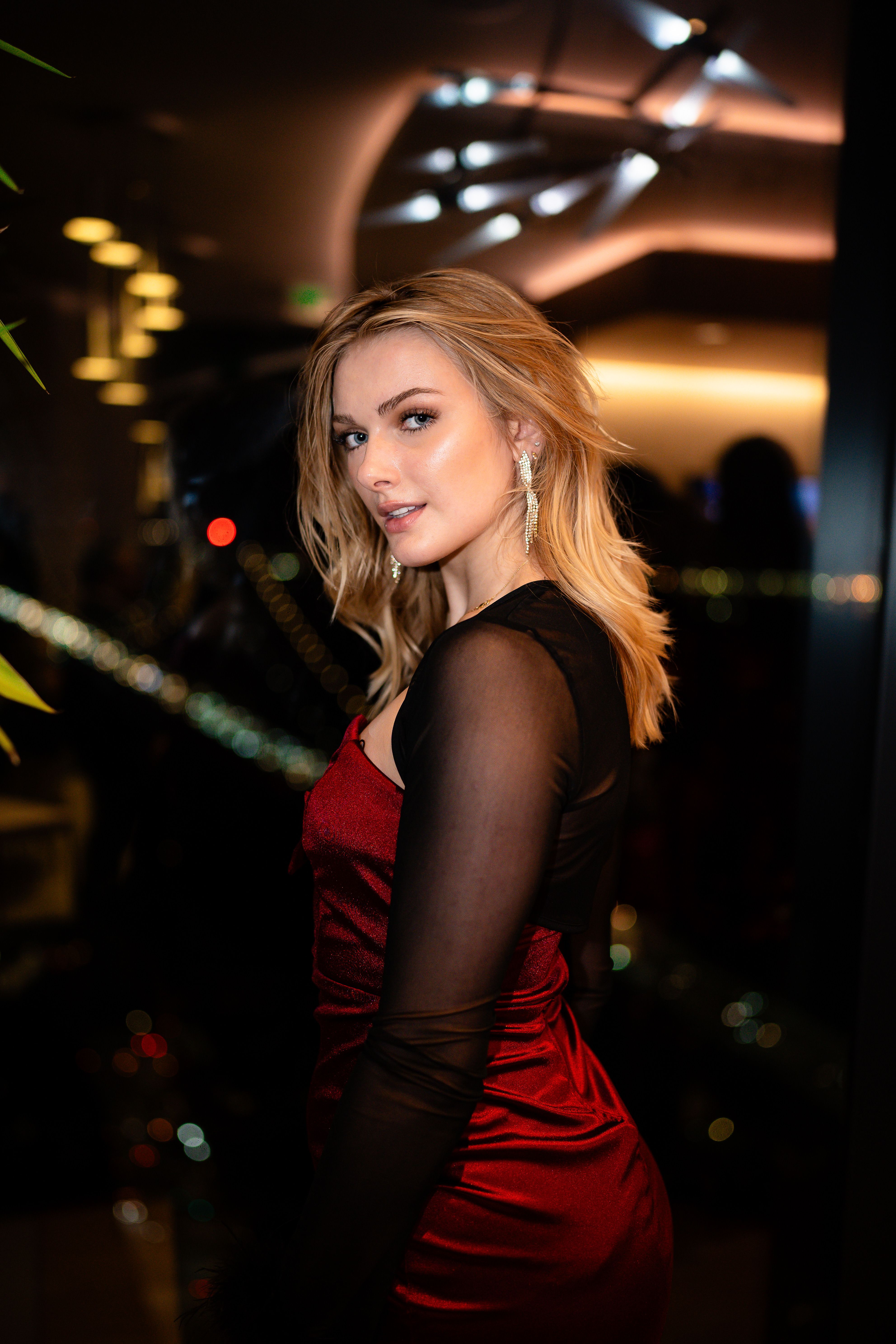 Elegant woman in red dress at night event · Free Stock Photo