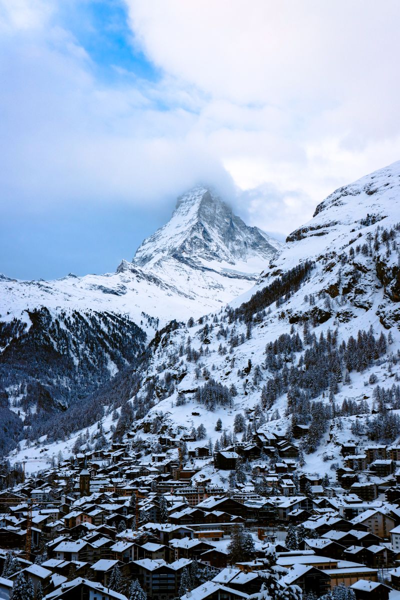Snow-covered chalets in Zermatt beneath the Matterhorn