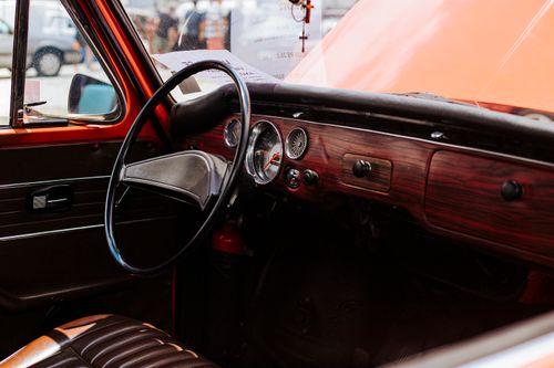 Free Close-up of a classic car dashboard with vintage design elements. Stock Photo