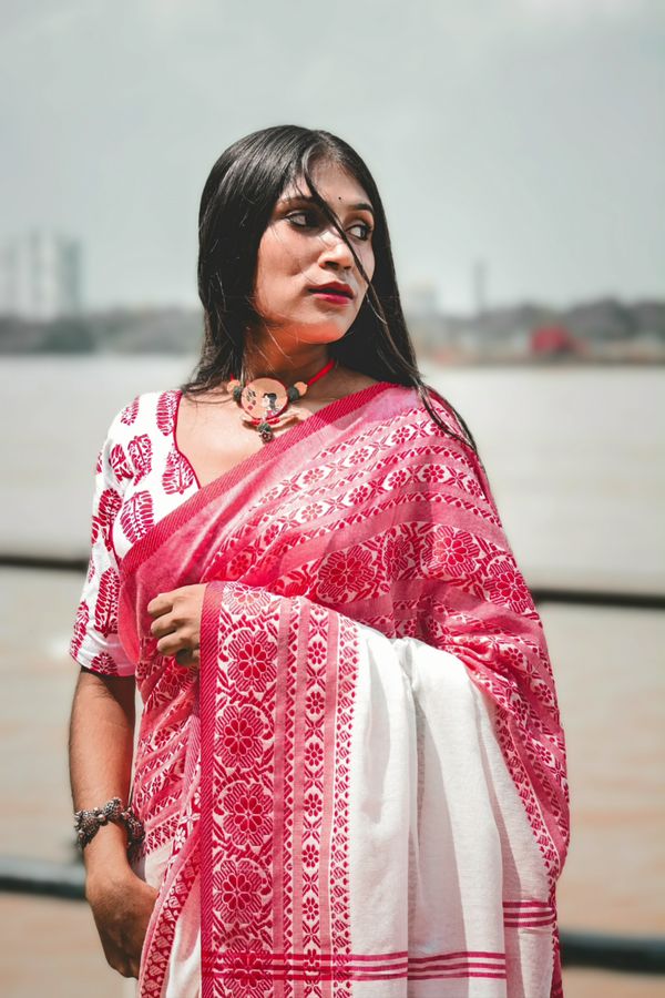 Traditional Indian Woman in Pink Saree Smiling Outdoors · Free Stock Photo