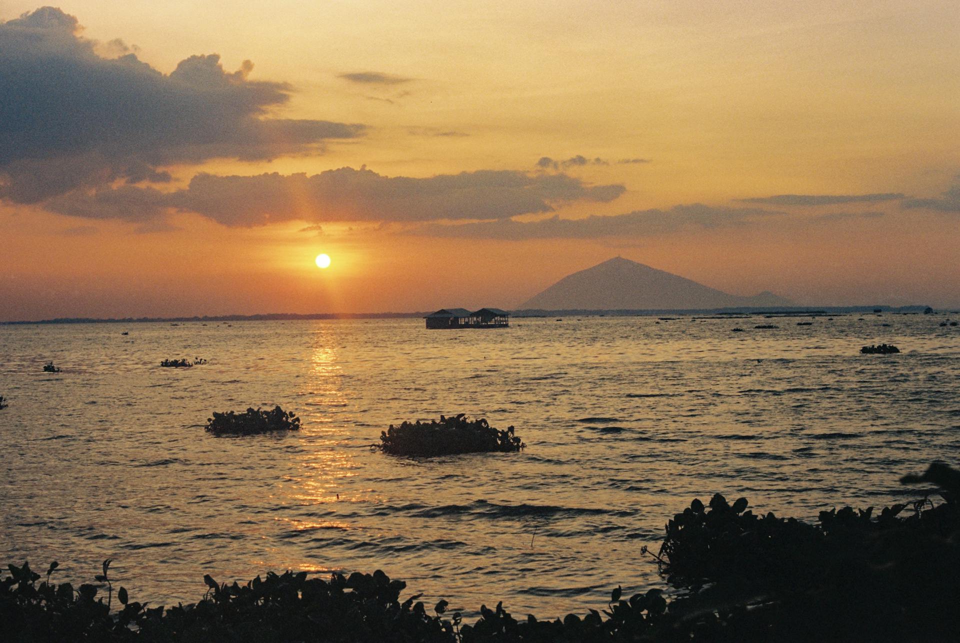 Breathtaking sunset view over the calm waters in Tây Ninh, Vietnam, highlighting a serene evening landscape.