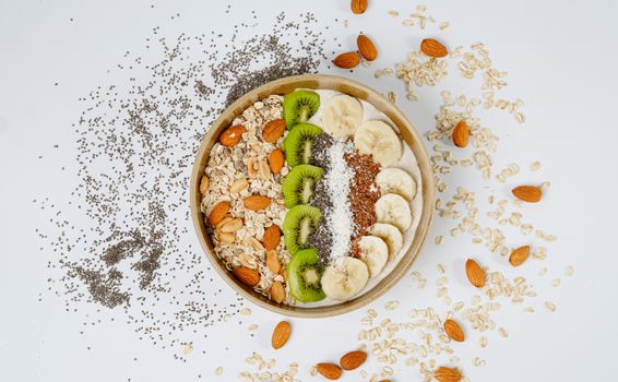 A delicious and nutritious breakfast bowl with kiwi, banana, almonds, and chia seeds.