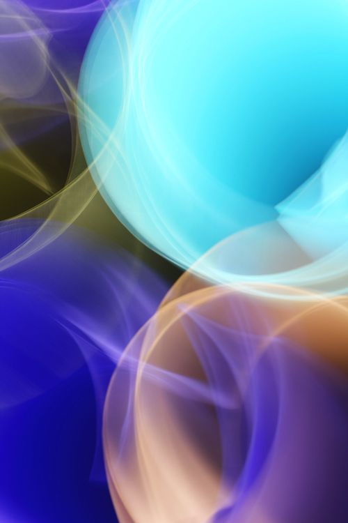Free Vibrant abstract image featuring colorful light swirls in blue and orange hues. Stock Photo