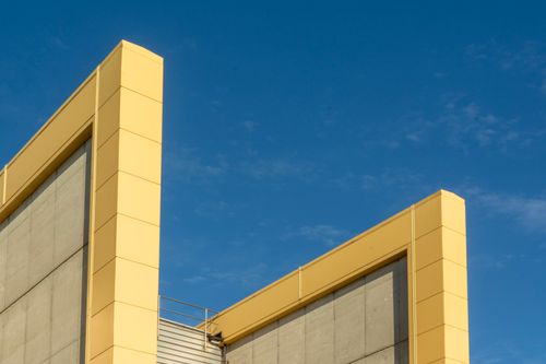 Free Minimalist architectural design with vibrant yellow frames and a clear blue sky. Stock Photo