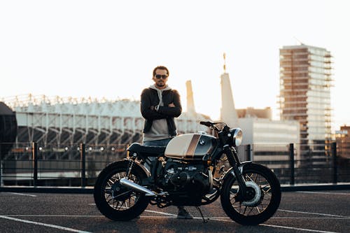 Man Standing Beside Motorcycle