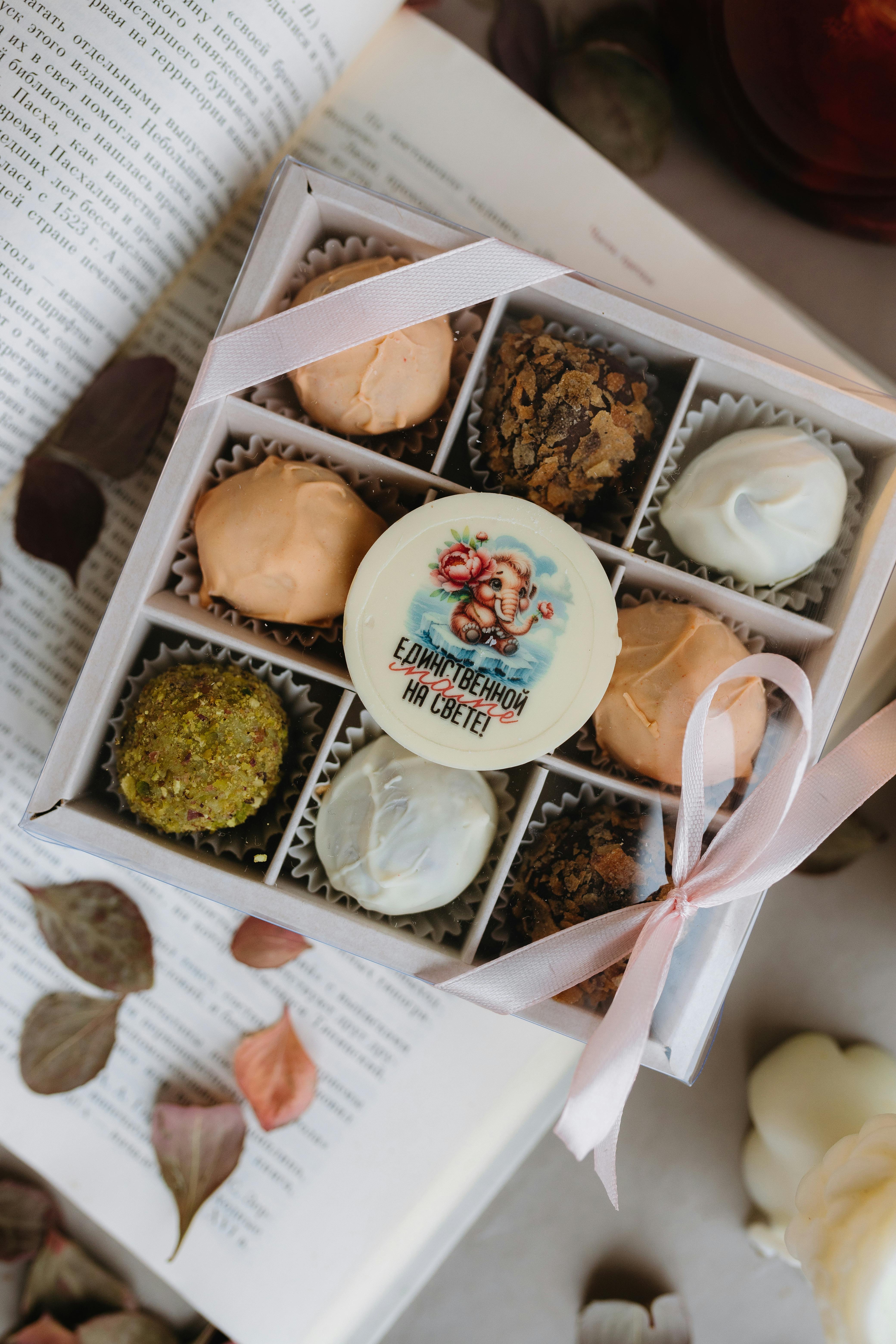 Elegant box of assorted chocolates with a decorative ribbon, perfect for gifting.