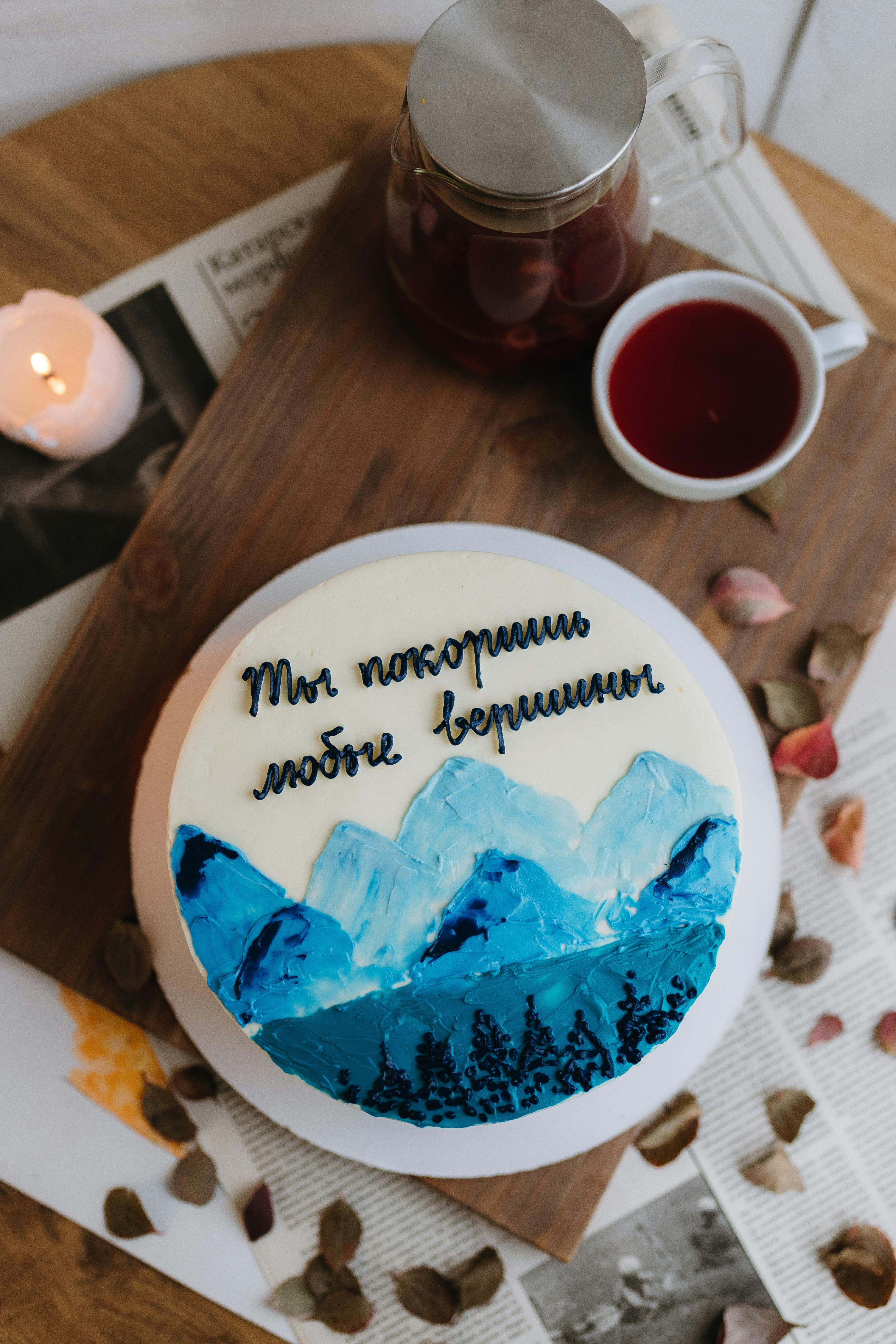 decorative cake with mountain design and russian inscription