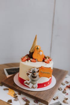 Colorful birthday cake featuring cartoon character and strawberries, ideal for celebrations.