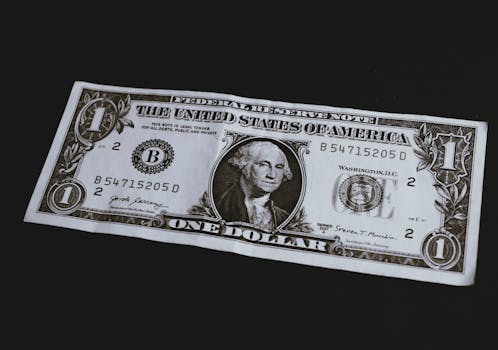High-resolution image of a one dollar bill with intricate details on a dark background.