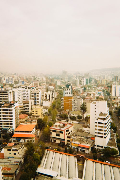 Free Aerial shot of a bustling modern city with high-rise buildings and sprawling streets. Stock Photo