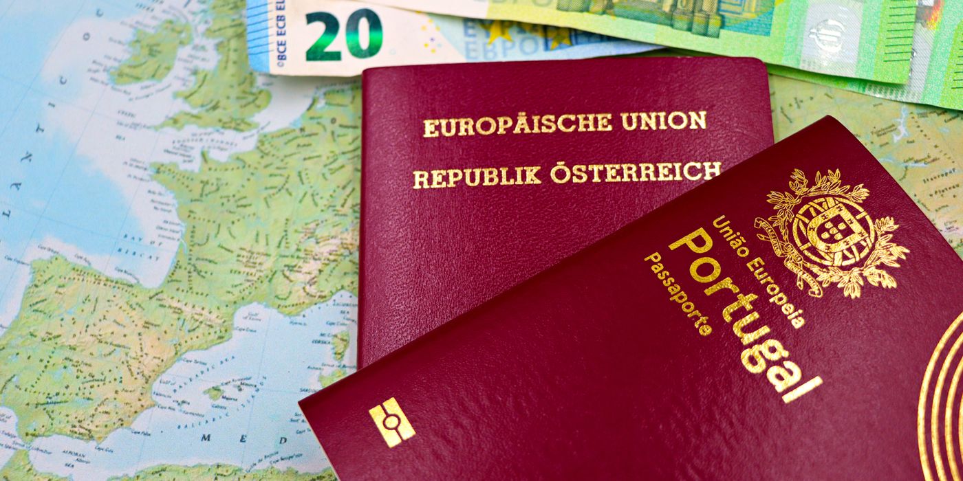Austrian and Portuguese passports on a European map with euro banknotes.
