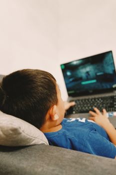 A student using a laptop to play Be Internet Awesome online safety games.