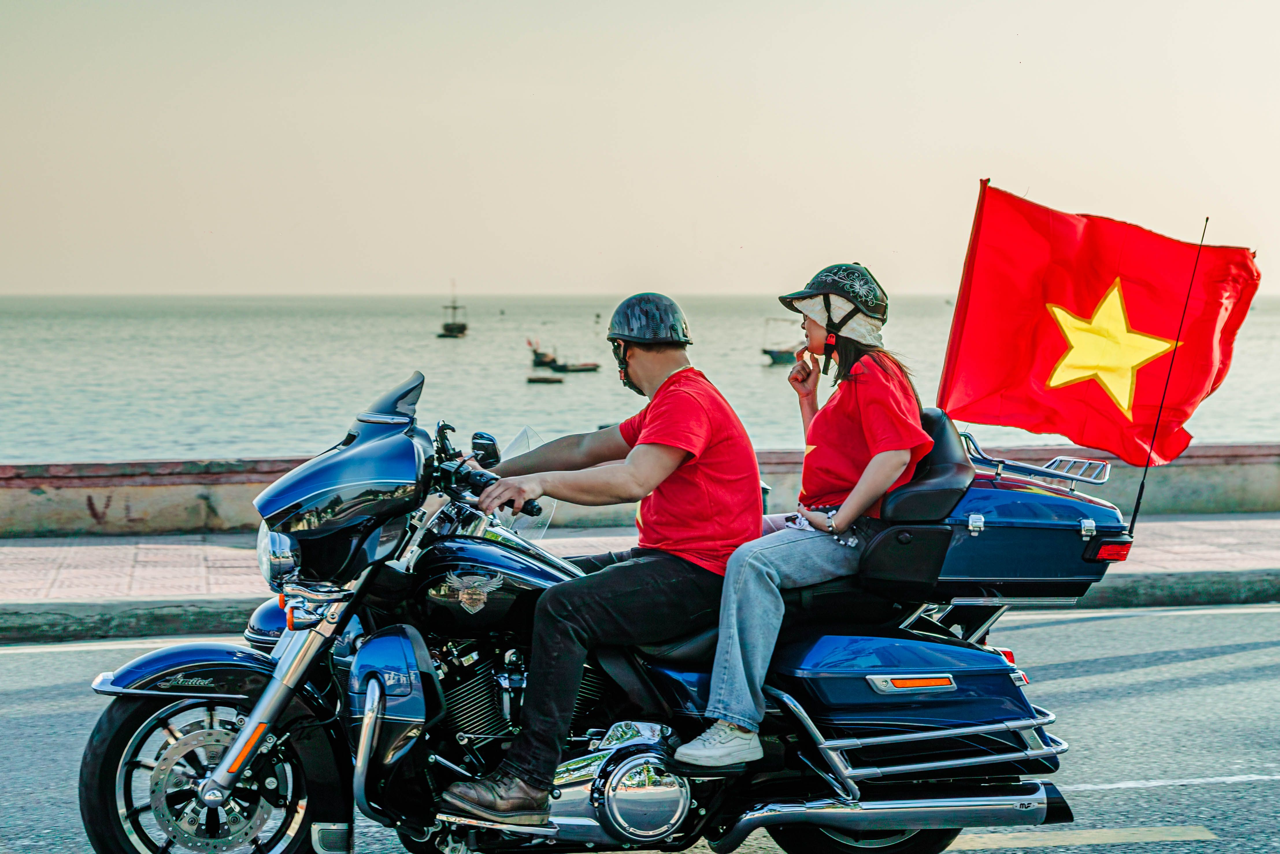 Vibrant Ride by the Ocean with Vietnamese Flag · Free Stock Photo