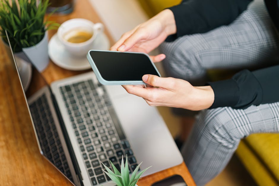 Person using laptop and phone to check search results - how to see if you are featured in ai overviews Person using laptop and phone to check search results - how to see if you are featured in ai overviews
