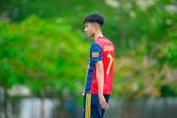 Teen Soccer Player in Vibrant Jersey Outdoors
