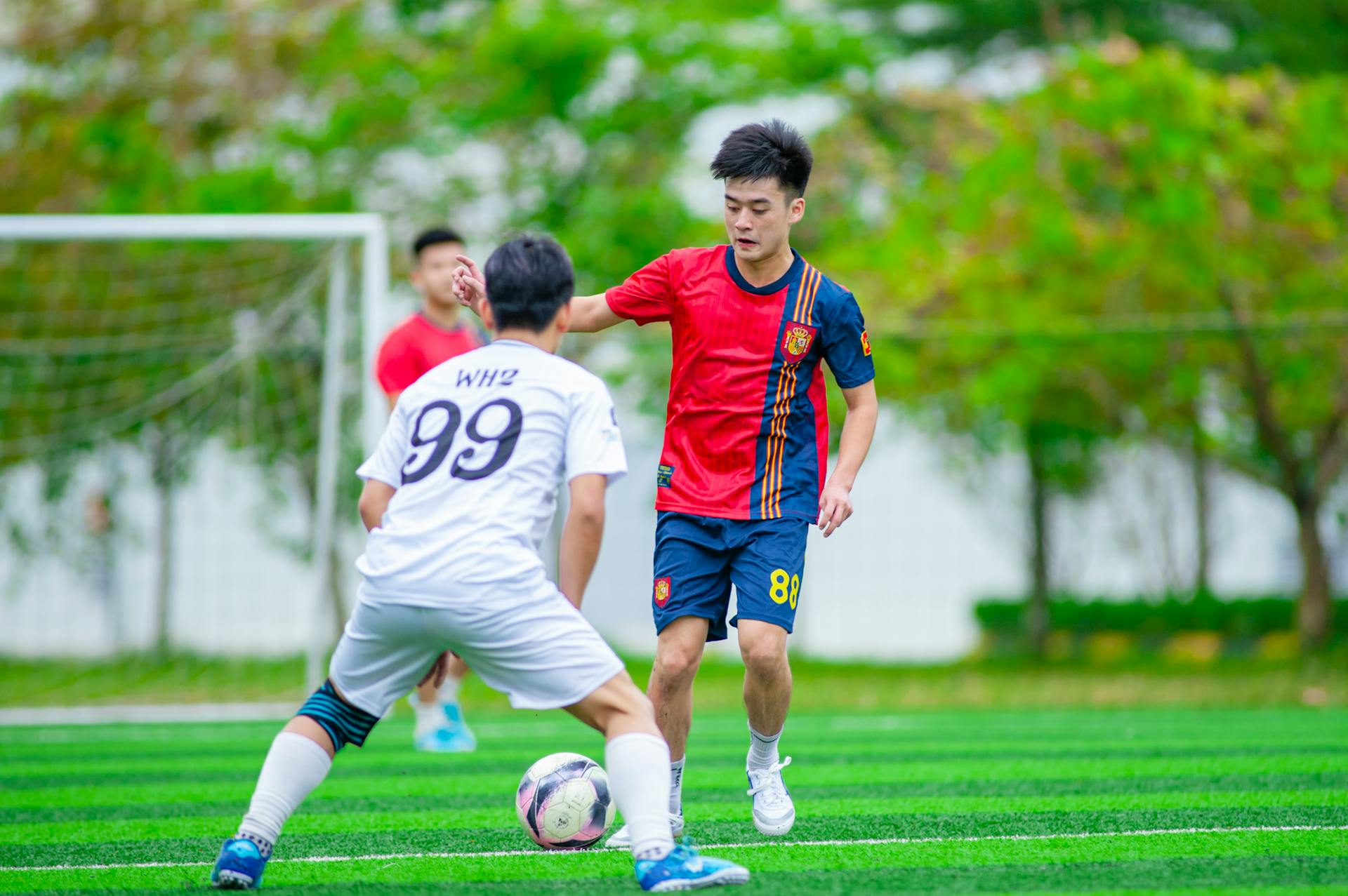 Young soccer players in action on a vibrant field in Hanoi, Vietnam. Energetic and competitive scene.