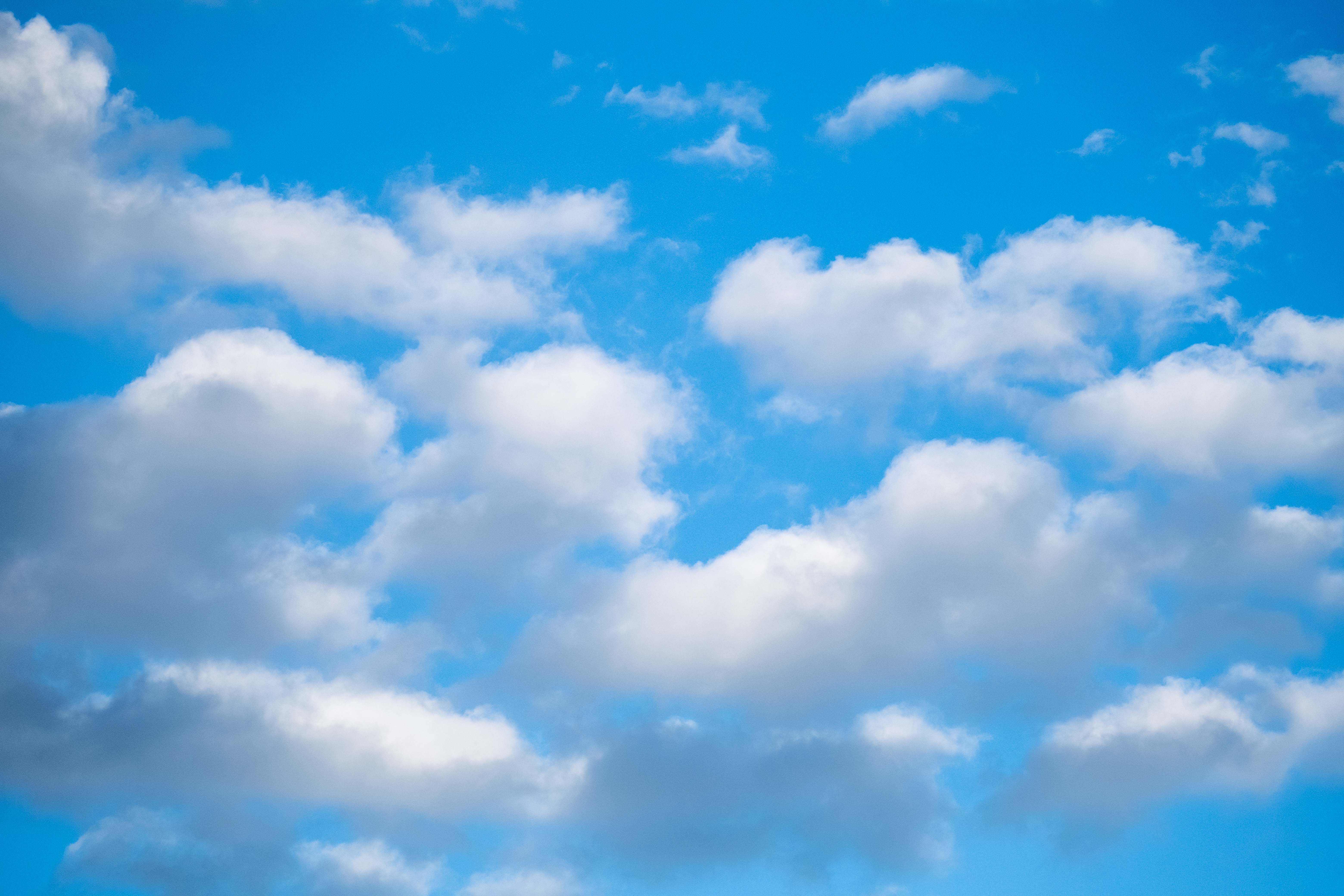 Bright Blue Sky with Fluffy White Clouds · Free Stock Photo
