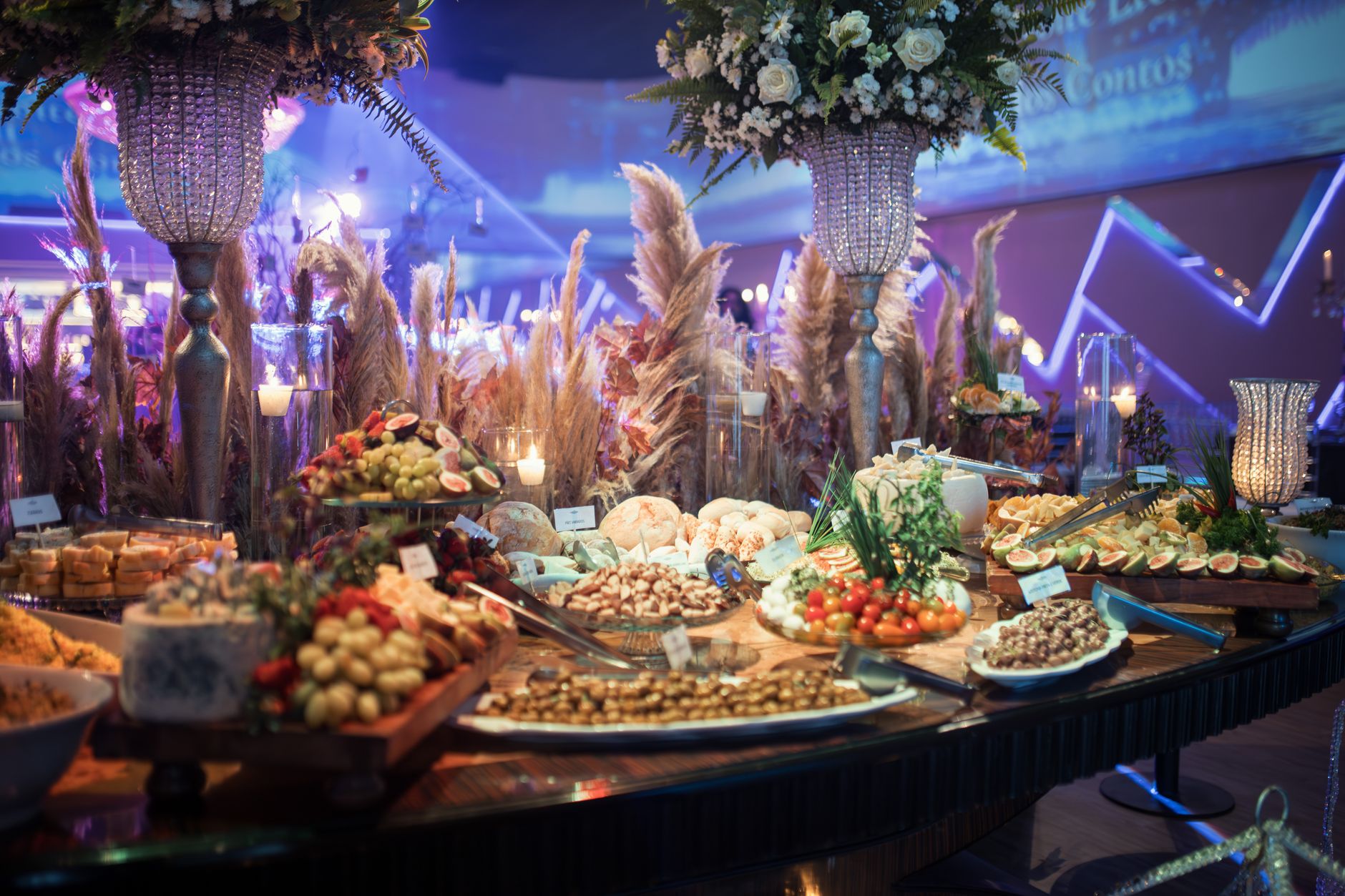 A lavishly decorated banquet table with a variety of gourmet dishes and elegant floral arrangements.