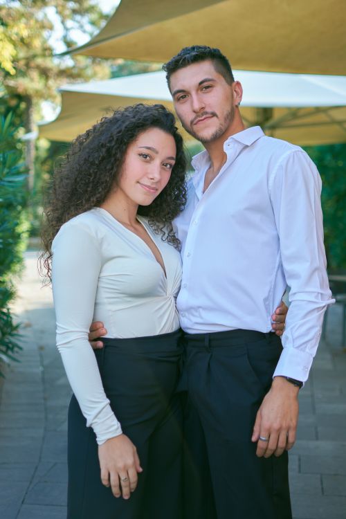 Free A stylish couple poses outdoors in elegant attire, showcasing confidence and charm. Stock Photo
