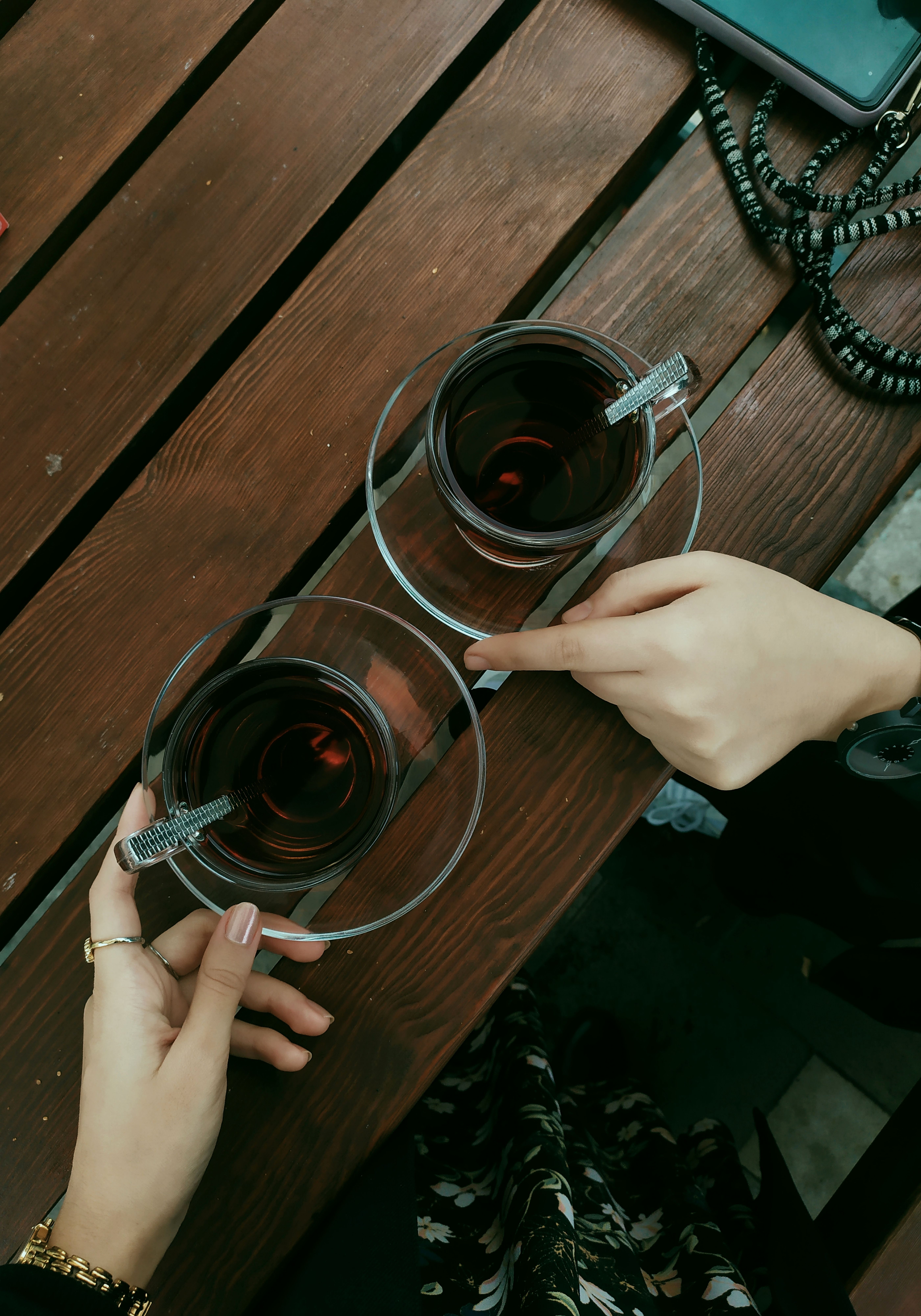 Two People Toasting with Tea on Rustic Table · Free Stock Photo