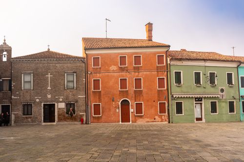 Free Charming colorful buildings lined up in the quiet streets of Burano, Venice, Italy. Stock Photo