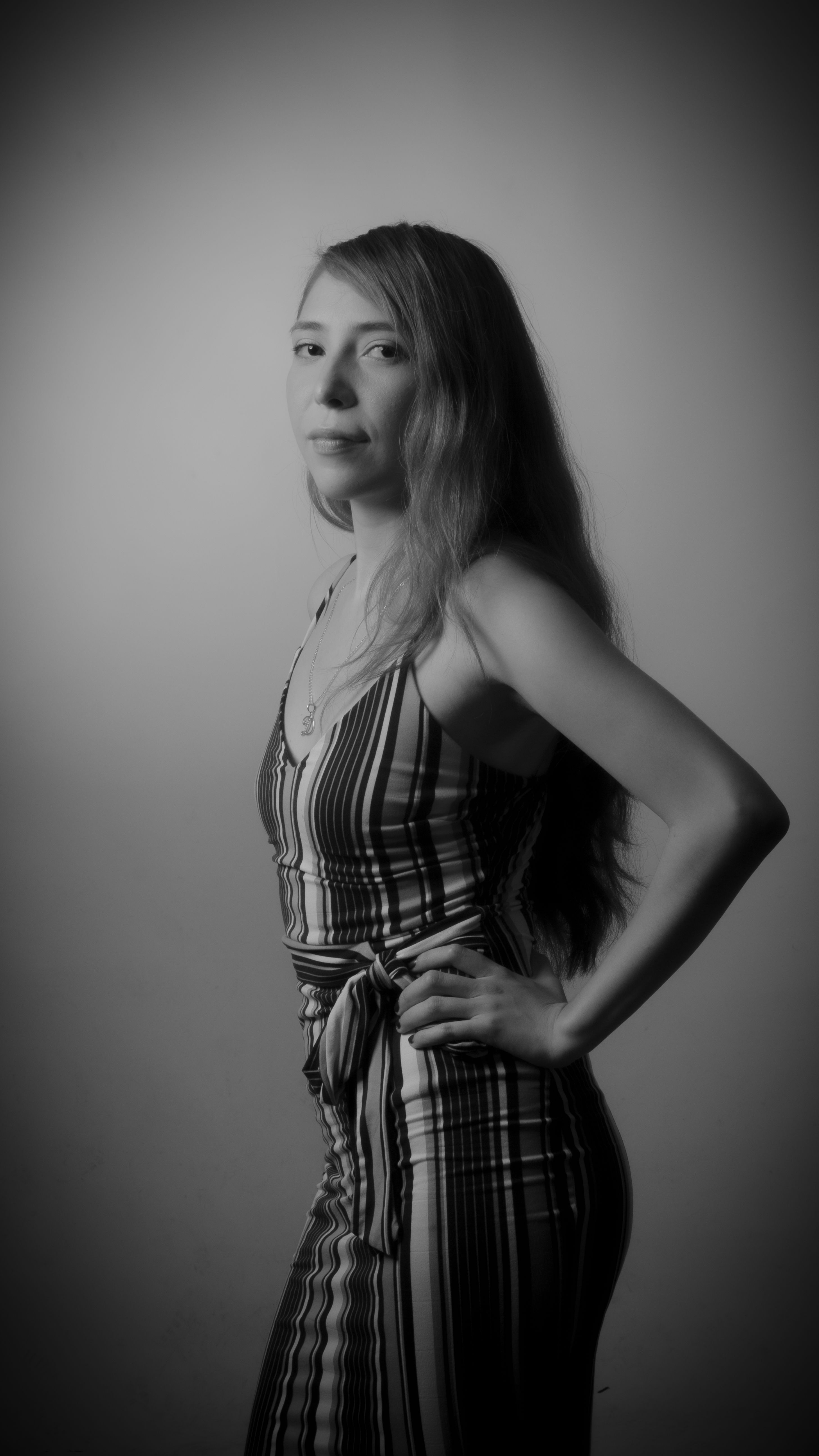 Elegant Portrait of Woman in Striped Dress · Free Stock Photo