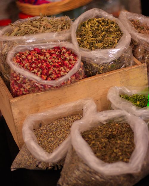 Free Vibrant display of herbs and spices in plastic bags at a market stall in Mexico. Stock Photo