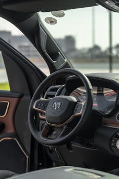 Detailed view of a Dodge Ram truck's interior focusing on the steering wheel and dashboard.
