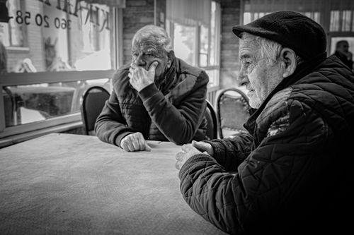 Free Black and white portrait capturing two older men in a candid moment at a café in Istanbul. Stock Photo