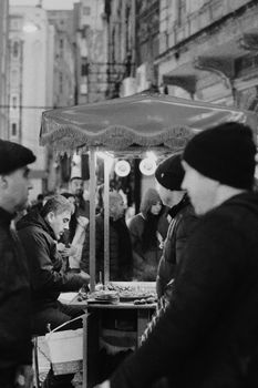 A lively street vendor scene on Istiklal Avenue in Istanbul, Turkey at night.