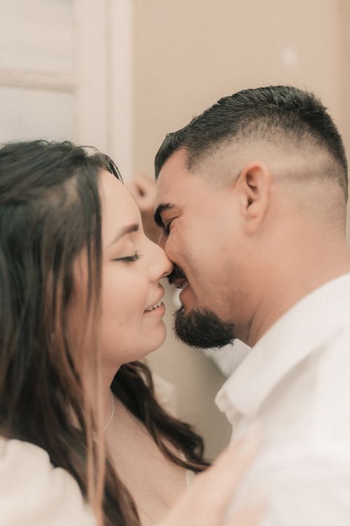 Free A close-up of a loving couple about to kiss, capturing a tender moment indoors. Stock Photo