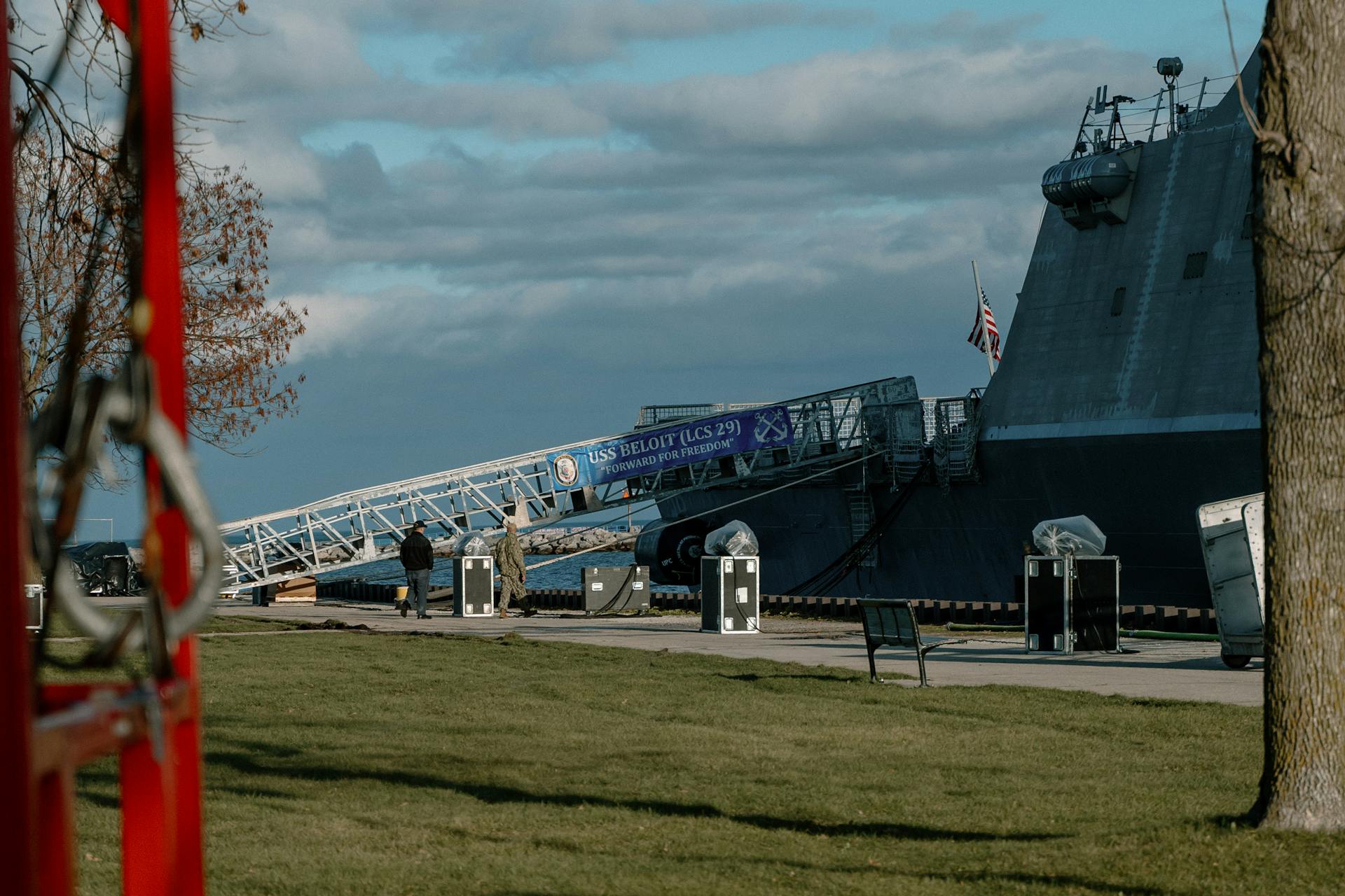 USS Beloit LCS-29 docked at Milwaukee's scenic waterfront with crew members on board.