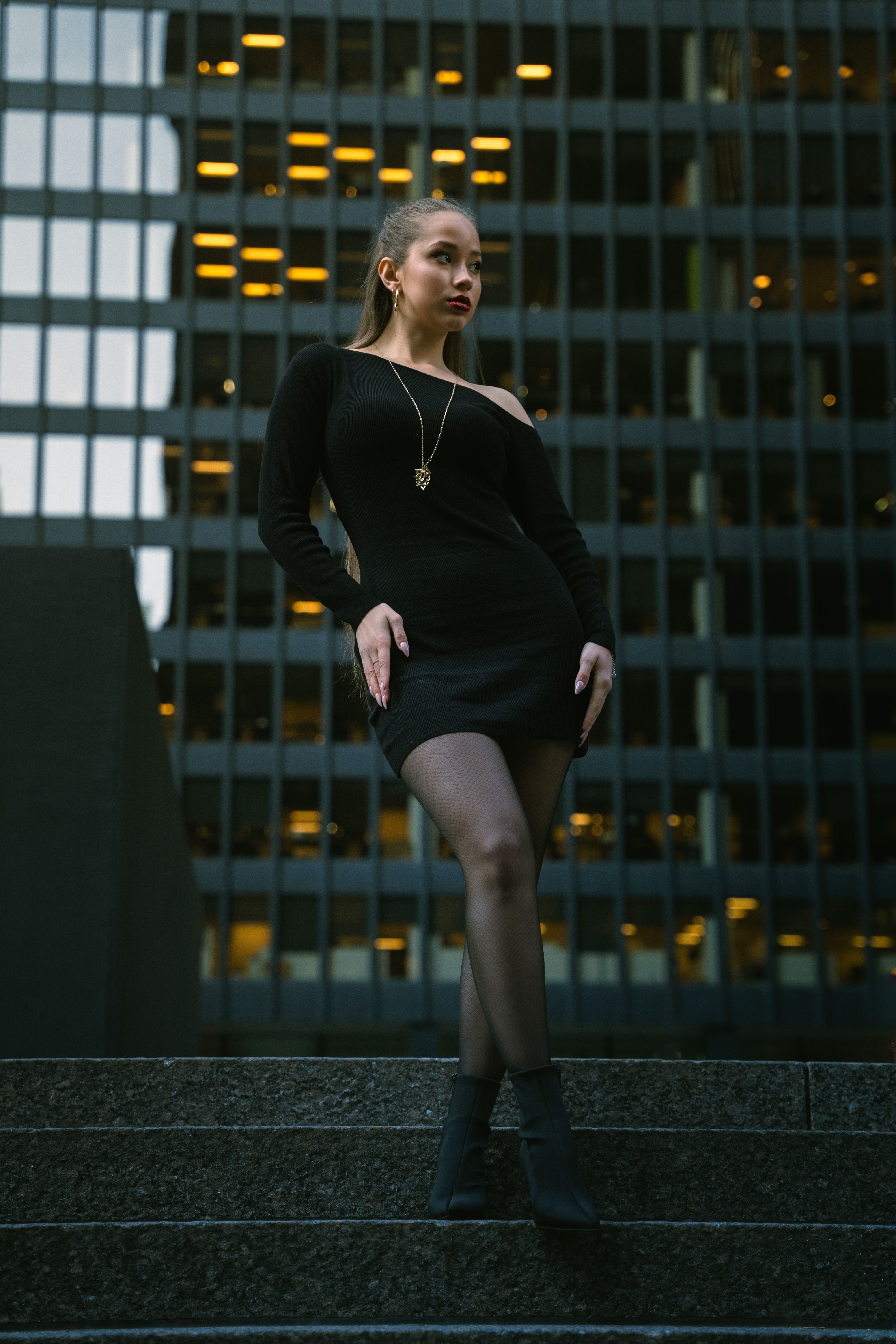 Stylish Woman in Black Dress Posing Downtown · Free Stock Photo
