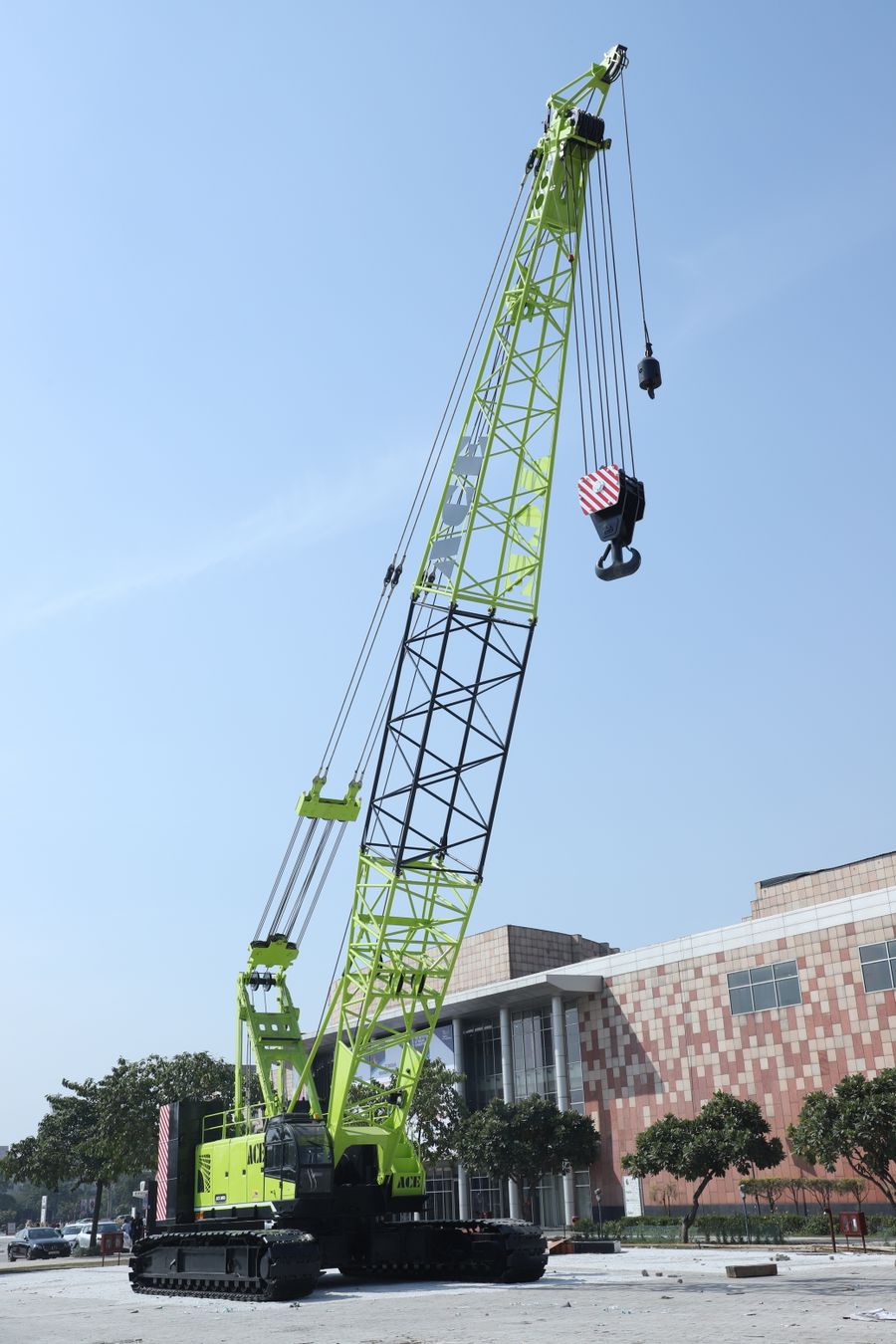 Green crawler crane with raised boom
