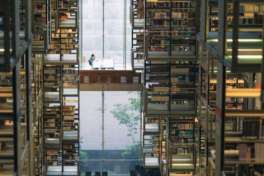 Inside view of a modern library with bookshelves and a central seating area in Mexico City.