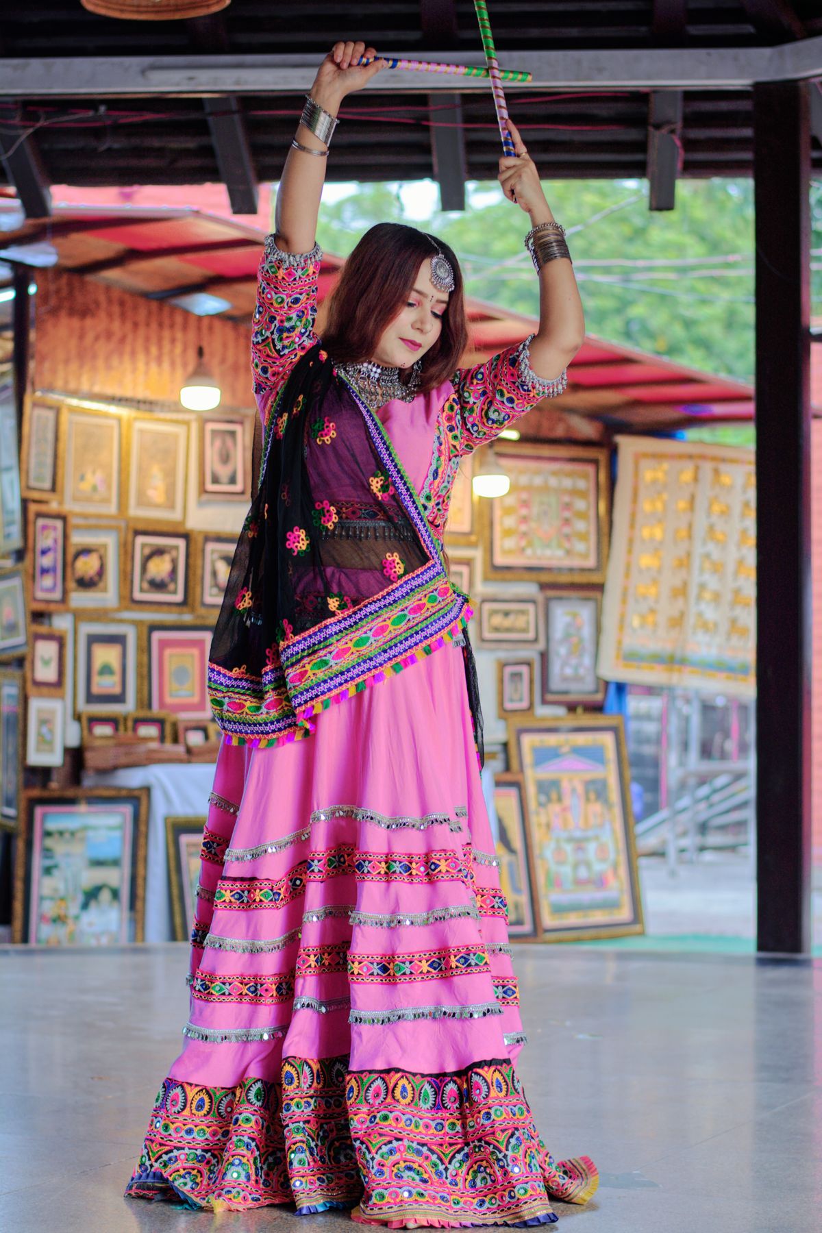 Woman in vibrant traditional Indian attire dancing expressively